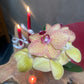 Orchid flower with two lit candles in the background